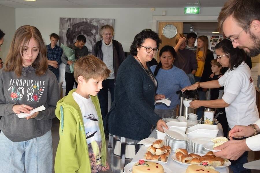 People handing out cake at church coffee